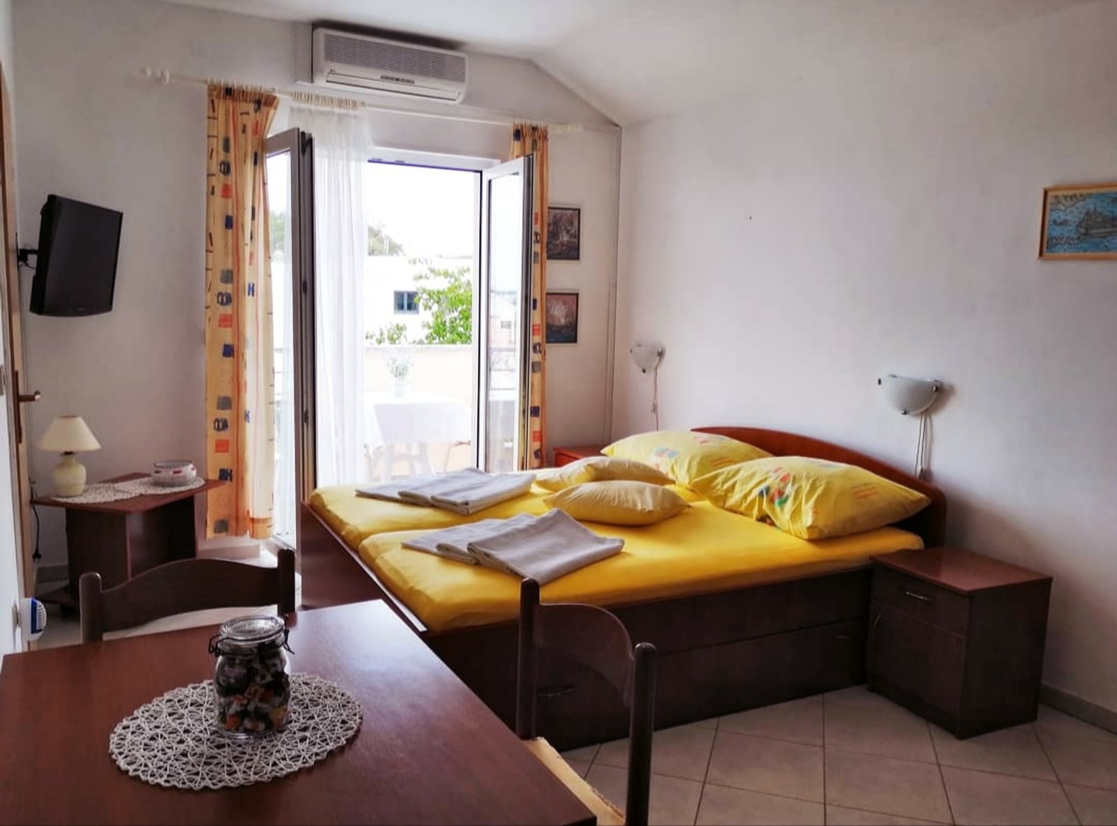Apartment 1 living area with double bed and sea-view balcony