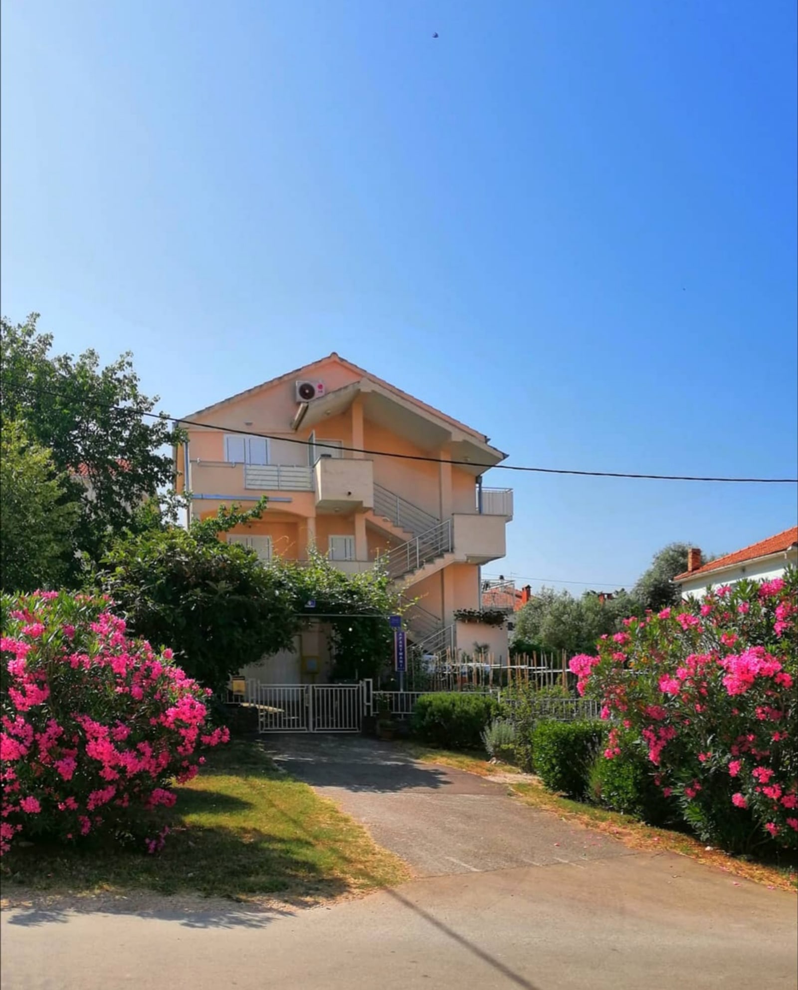 Apartments Diklo exterior with garden path and balconies